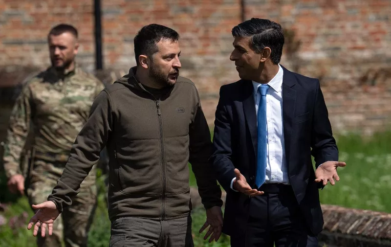 Britain's Prime Minister Rishi Sunak (R) talks with Ukraine's President Volodymyr Zelensky, as he walks with him to a waiting Chinook helicopter following their meeting at Chequers, the prime minister's official country residence, near Ellesborough, northwest of London, on May 15, 2023. Ukrainian President Volodymyr Zelensky met in Britain on Monday with Prime Minister Rishi Sunak, who pledged "hundreds" of both air defence missiles and long-range attack drones to fend off Russia's invasion. (Photo by Carl Court / POOL / AFP)