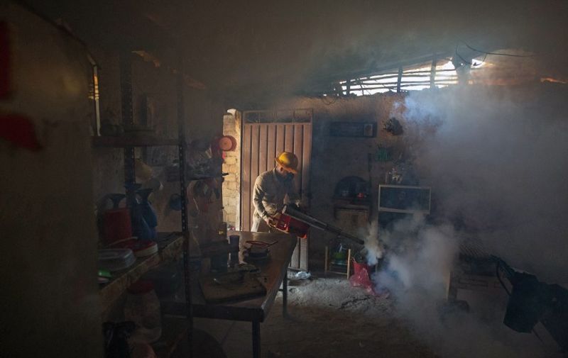 An employee of the Health Secretariat fumigates a home against the Aedes aegypti mosquito to prevent the spread of the Zika, Chikungunya and Dengue in Acapulco, Guerrero State, Mexico on February 2, 2016.  AFP PHOTO/ Pedro PARDO / AFP / Pedro PARDO