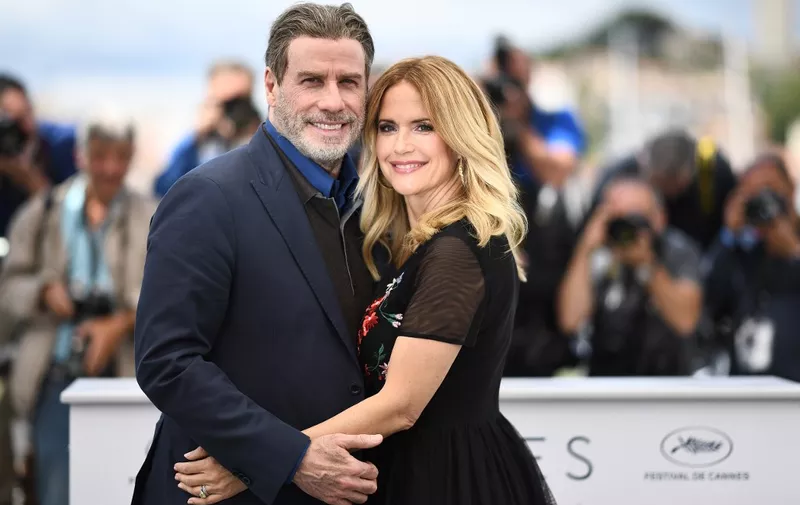 (FILES) In this file photo taken on May 15, 2018 US actor John Travolta (L) and his wife US actress Kelly Preston pose during a photocall for the film "Gotti" at the 71st edition of the Cannes Film Festival in Cannes, southern France. - Kelly Preston, US actress and wife of US actor John Travolta, died after a battle with breast cancer at the age of 57, US media reported on July 12, 2020. (Photo by Anne-Christine POUJOULAT / AFP)