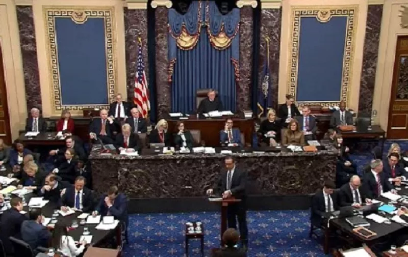 This still image taken from a US Senate webcast shows Deputy White House Counsel Mike Purpura (C, bottom), with  US Supreme Court Chief Justice John Roberts (C) presiding, arrives to speak in the Senate Chamber at the US Capitol during the impeachment trial, on January 25, 2020 in Washington, DC. - US President Donald Trump's lawyers began their defense arguments at his historic impeachment trial, after Democratic prosecutors spent three days making their case that Trump abused his power and then tried to block a Congressional probe. (Photo by HO / US Senate TV / AFP) / RESTRICTED TO EDITORIAL USE - MANDATORY CREDIT "AFP PHOTO / US SENATE TV" - NO MARKETING - NO ADVERTISING CAMPAIGNS - DISTRIBUTED AS A SERVICE TO CLIENTS