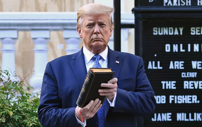 US President Donald Trump holds up a Bible outside of St John's Episcopal church across Lafayette Park in Washington, DC on June 1, 2020. - US President Donald Trump was due to make a televised address to the nation on Monday after days of anti-racism protests against police brutality that have erupted into violence.
The White House announced that the president would make remarks imminently after he has been criticized for not publicly addressing in the crisis in recent days. (Photo by Brendan Smialowski / AFP)