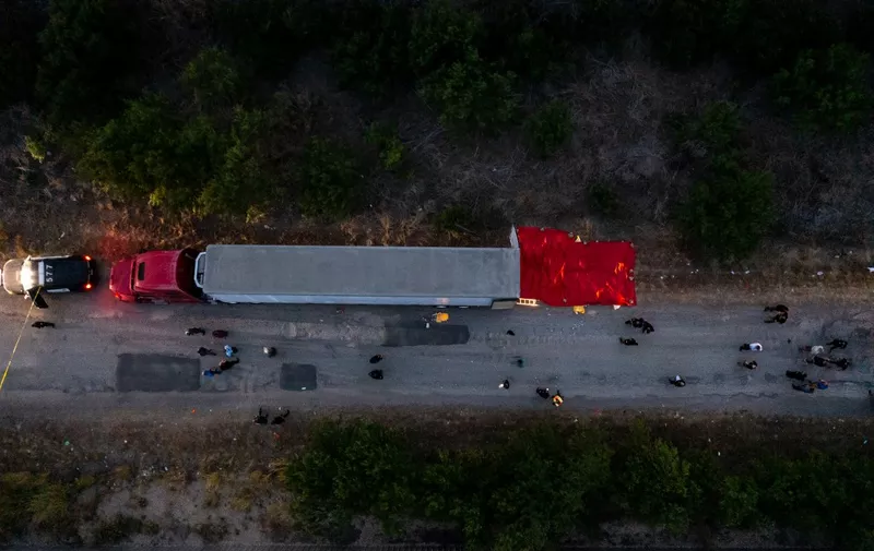 SAN ANTONIO, TX - JUNE 27: In this aerial view, members of law enforcement investigate a tractor trailer on June 27, 2022 in San Antonio, Texas. According to reports, at least 46 people, who are believed migrant workers from Mexico, were found dead in an abandoned tractor trailer. Over a dozen victims were found alive, suffering from heat stroke and taken to local hospitals.   Jordan Vonderhaar/Getty Images/AFP (Photo by Jordan Vonderhaar / GETTY IMAGES NORTH AMERICA / Getty Images via AFP)