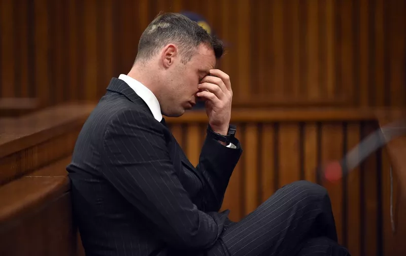 (FILES) In this file photo taken on June 13, 2016 South African Paralympian Oscar Pistorius gestures at Pretoria High Court during the sentencing hearing set to send him back to jail for murdering his girlfriend three years ago. - The request for parole of the former South African Paralympic champion Oscar Pistorius, convicted of the murder of his girlfriend Reeva Steenkamp, was refused on March 31, 2023 according to the lawyer for the family of the victim. (Photo by Phill Magakoe / AFP)
