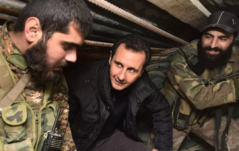 A handout picture released by the Syrian Arab News Agency (SANA) shows Syrian President Bashar al-Assad (C) talking with troops during a reported visit to the eastern Damascus district of Jobar on December 31, 2014, as pro-government forces and rebels continue their fight for control of the outskirts of the capital. A total of more than 200,000 people have been killed since the conflict began in March 2011, including more than 44,200 Syrian soldiers. AFP PHOTO / HO / SANA
=== RESTRICTED TO EDITORIAL USE - MANDATORY CREDIT "AFP PHOTO / HO / SANA" - NO MARKETING NO ADVERTISING CAMPAIGNS - DISTRIBUTED AS A SERVICE TO CLIENTS ===