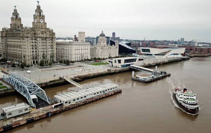 (FILES) In this file photo taken on October 02, 2020 shows a Mersey Ferry pulling away from Pier Head, near the Liver Building, as it travels on the River Mersey. - Britain on July 21, 2021 expressed grave disappointment after the UN's cultural agency UNESCO voted to remove Liverpool from its list of world heritage sites because of overdevelopment. (Photo by Paul ELLIS / AFP)
