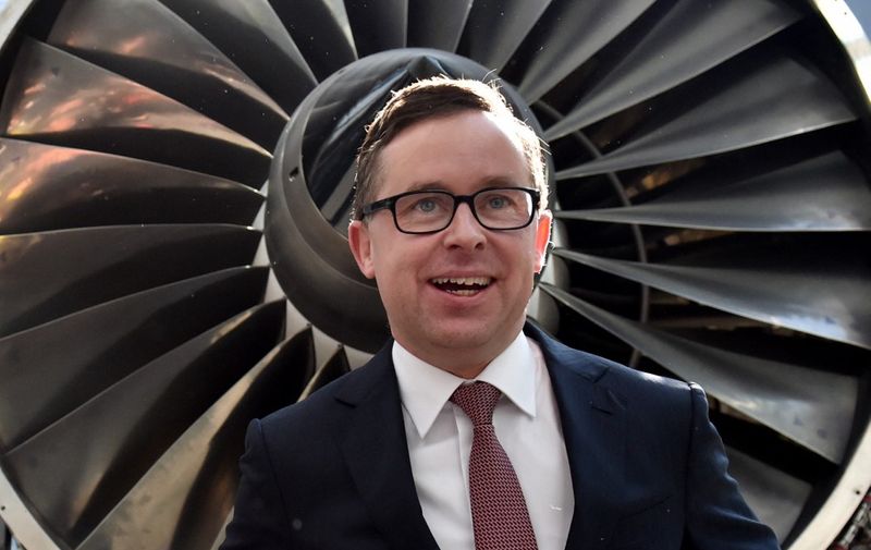 CORRECTION
Qantas chief executive Alan Joyce poses for photos after a press conference in Sydney on August 20, 2015.  Australia carrier Qantas roared back into the black in a stunning turnaround of fortunes driven by aggressive cost-cutting, while placing an order for eight Boeing Dreamliners.   AFP PHOTO / SAEED KHAN (Photo by Saeed KHAN / AFP)