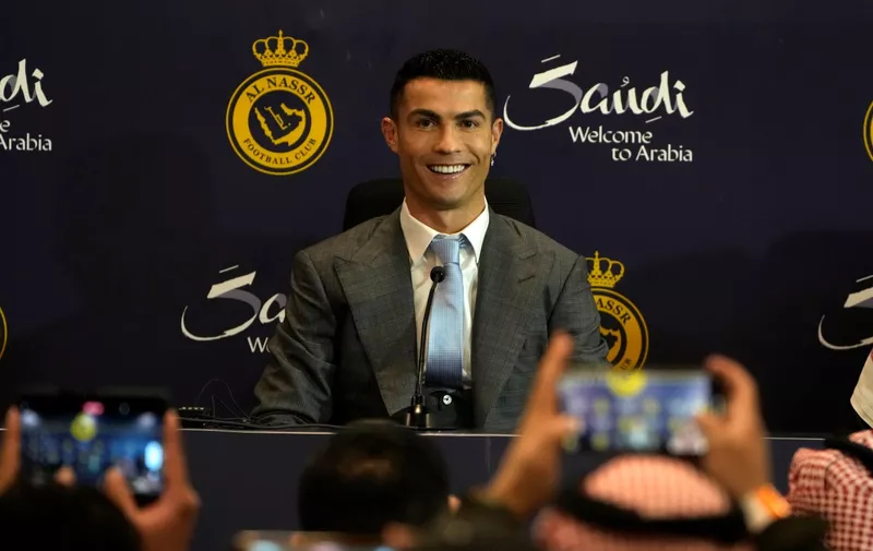 Cristiano Ronaldo smiles during a press conference for his official unveiling as a new member of Al Nassr soccer club in in Riyadh, Saudi Arabia, Tuesday, Jan. 3, 2023. Ronaldo, who has won five Ballon d'Ors awards for the best soccer player in the world and five Champions League titles, will play outside of Europe for the first time in his storied career. (AP Photo/Amr Nabil)