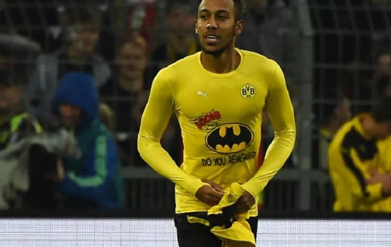 Dortmund's Gabonese striker Pierre-Emerick Aubameyang celebrates scoring showing his Batman shirt during the German first division football Bundesliga match Borussia Dortmund vs FC Schalke 04 on November 8, 2015, 2015 in Dortmund, western Germany. 

RESTRICTIONS: DURING MATCH TIME: DFL RULES TO LIMIT THE ONLINE USAGE TO 15 PICTURES PER MATCH AND FORBID IMAGE SEQUENCES TO SIMULATE VIDEO. 
==RESTRICTED TO EDITORIAL USE ==
FOR FURTHER QUERIES PLEASE CONTACT THE DFL DIRECTLY AT + 49 69 650050. / AFP / PATRIK STOLLARZ