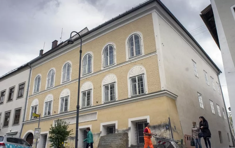 (FILES) This file photo taken on April 17, 2015 shows a memorial stone stands outside the house where Adolf Hitler was born in Braunau Am Inn, Austria on April 18, 2015.  
The house where Adolf Hitler was born is to be torn down to stop it from becoming a neo-Nazi shrine after years of bitter legal wrangling, Austria's interior minister said October 17, 2016. / AFP PHOTO / JOE KLAMAR