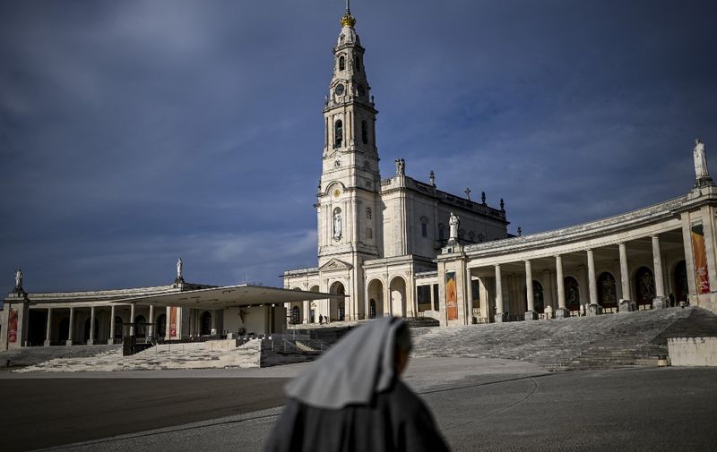 A nun walks at Fatima shrine in Leiria on March 3, 2023. (Photo by PATRICIA DE MELO MOREIRA / AFP)