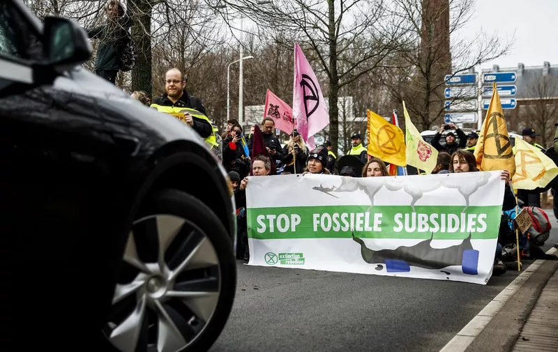 Climate activists from Extinction Rebellion block the Utrechtsebaan during a demonstration against fossil government support, in The Hague, on February 3, 2024. The climate organization says it wants to further increase the pressure on politicians. (Photo by Sem van der Wal / ANP / AFP) / Netherlands OUT