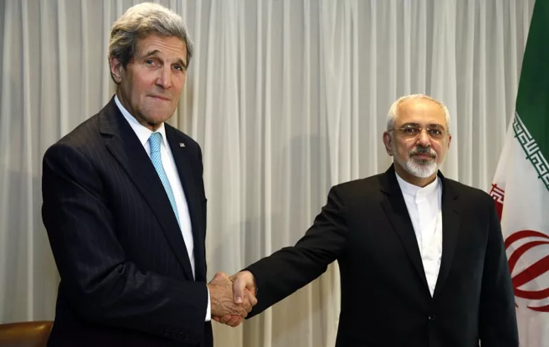 Iranian Foreign Minister Mohammad Javad Zarif shakes hands on January 14, 2015 with US State Secretary John Kerry in Geneva. Zarif said on January 14 that his meeting with his US counterpart was vital for progress on talks on Tehran's contested nuclear drive. Under an interim deal agreed in November 2013, Iran's stock of fissile material has been diluted from 20 percent enriched uranium to five percent, in exchange for limited sanctions relief.   AFP PHOTO / POOL / RICK WILKING