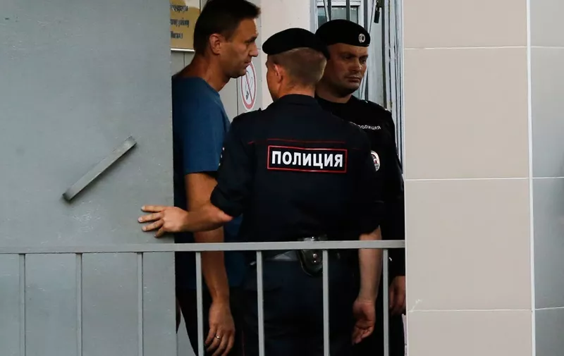 Russian opposition leader Alexei Navalny (L) walks outside the Danilovsky police station in Moscow after being detained on August 25, 2018. - Navalny was detained outside his home in Moscow on August 25 for reasons that were not immediately clear, his spokeswoman said on Twitter. (Photo by Maxim ZMEYEV / AFP)