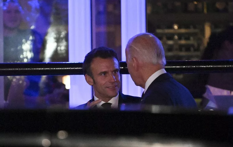 French President Emmanuel Macron chats with US President Joe Biden as they leave Fiola Mare restaurant after a private dinner in Washington, DC, on November 30, 2022. (Photo by ROBERTO SCHMIDT / AFP)