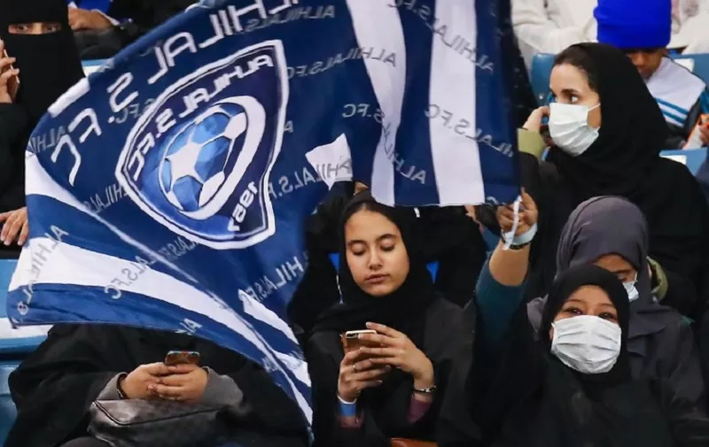 Female supporters of Saudi's Al-Hilal attend their team's football match against Al-Ittihad in the Saudi Pro League at the King Fahd International Stadium in Riyadh on January 13, 2018.
Saudi Arabia allowed women to enter a football stadium for the first time to watch a match on January 12, as the ultra-conservative kingdom eases strict decades-old rules separating the sexes. / AFP PHOTO / Ali AL-ARIFI