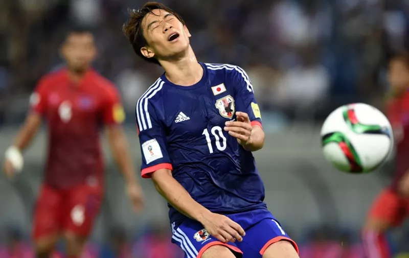 Japan's midfielder Shinji Kagawa (C) reacts during their 2018 FIFA World Cup qualifying football match against Cambodia in Saitama on September 3, 2015.          AFP PHOTO / TOSHIFUMI KITAMURA