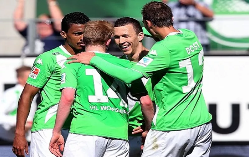 Wolfsburg's Croatian midfielder Ivan Perisic (2nd R) celebrates after scoring with Wolfsburg's Brazilian midfielder Luiz Gustavo (L), Wolfsburg's Belgian midfielder Kevin De Bruyne (2nd L) and Wolfsburg's Dutch striker Bas Dost (R) during the German first division Bundesliga football match between VfL Wolfsburg and Hannover 96 at the Volkswagen Arena in Wolfsburg, central Germany, on May 2, 2015.  AFP PHOTO / RONNY HARTMANN

RESTRICTIONS - DFL RULES TO LIMIT THE ONLINE USAGE DURING MATCH TIME TO 15 PICTURES PER MATCH. IMAGE SEQUENCES TO SIMULATE VIDEO IS NOT ALLOWED AT ANY TIME. FOR FURTHER QUERIES PLEASE CONTACT DFL DIRECTLY AT + 49 69 650050.