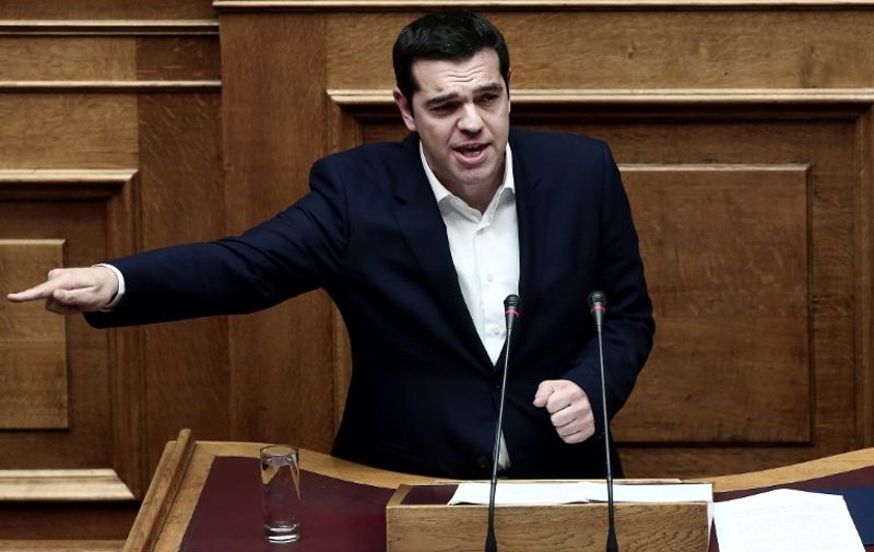 Greek Prime Minister Alexis Tsipras delivers a speech during a parliamentary session in Athens on December 5, 2015. 
Greek lawmakers are expected to vote late on Saturday for the 2016 budget, with its economic forecasts revised upward to show near zero growth in 2015 and a small contraction next year for the debt-ridden country in its sixth year of austerity. / AFP / ANGELOS TZORTZINIS