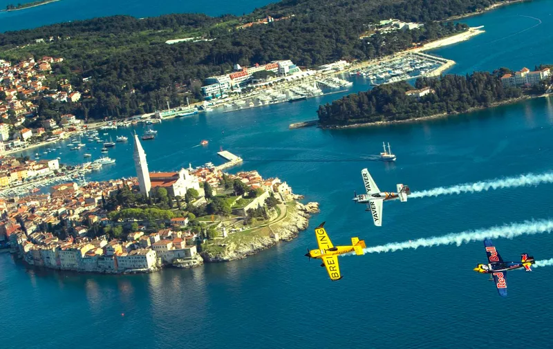Nigel Lamb of Great Britain, Hannes Arch of Austria and Peter Besenyei of Hungary fly in front of the city of Rovinj prior to the second stage of the Red Bull Air Race World Championship in Rovinj, Croatia on April 10, 2014. // J√∂rg Mitter/Red Bull Content Pool // P-20140410-00133 // Usage for editorial use only // Please go to www.redbullcontentpool.com for further information. //