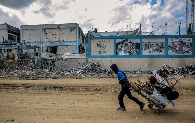 A man walks past the damaged Gaza City headquarters of the United Nations Relief and Works Agency for Palestine Refugees (UNRWA) on February 15, 2024, amid ongoing battles between Israel and the militant group Hamas. Several countries -- including the United States, Britain, Germany and Japan -- have suspended funding to the UNRWA agency in response to Israeli allegations that some of its staff members participated in the October 7 attack by Hamas militants. (Photo by AFP)
