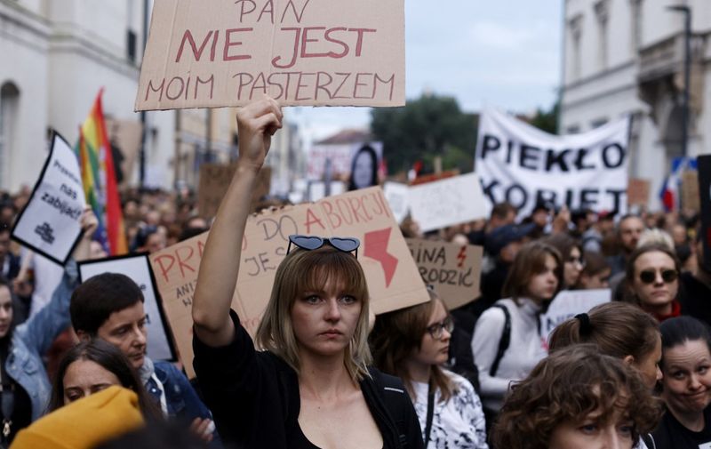 A demonstrator holds up a placard reading 'The Lord is not my shepherd' in downtown Warsaw on June 14, 2023, as people take to the streets to protest under the title 'Not one more' and 'Stop killing us' against the legislation on abortion after the death of the pregnant woman. Several thousand people took to streets in Poland Wednesday to protest a near-total ban on abortion that they blame for a new case of a death of a pregnant woman. Women rights groups organised gatherings in more than 50 Polish towns and cities, with protesters chanting "disgrace" and carrying pictures of the victim, 33-year-old Dorota Lalik. Lalik died in a hospital in Nowy Targ, southern Poland on May 24, three days after having been admitted there when her waters broke. She died of septicaemia after her 20-week-old foetus died in the womb, her family said in a statement. (Photo by Wojtek Radwanski / AFP)