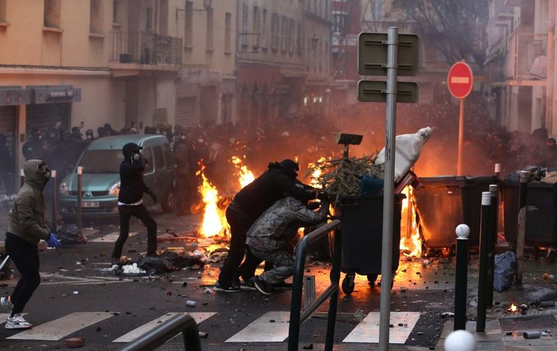 Protesters clash with police in Bastia on March 13, 2022, following a rally in hommage to the pro-independence activist Yvan Colonna who was assaulted in the prison of Arles. - Violent clashes broke out between protesters and police on France's Mediterranean island of Corsica where local anger is still growing over the assault in prison of a nationalist figure. Colonna was jailed in the south of France with authorities long rejecting his demand to be transferred to Corsica, saying his offence made him a special status detainee. (Photo by Pascal POCHARD-CASABIANCA / AFP)