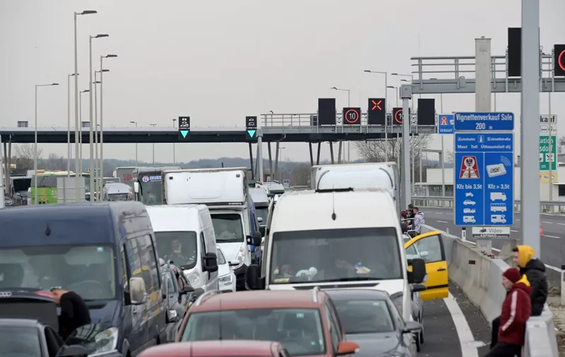 Trucks and cars are stuck in a traffic jam at the border crossing Nickelsdorf after the Austuran-Hungarian border was closed on March 17, 2020. (Photo by HERBERT P. OCZERET / APA / AFP) / Austria OUT