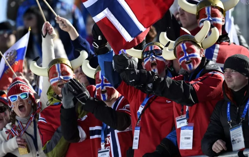 Norway's fans wave with national flag during the Women's Cross-Country Skiing 7,5km + 7,5km Skiathlon at the Laura Cross-Country Ski and Biathlon Center during the Sochi Winter Olympics on February 8, 2014 in Rosa Khutor.   
AFP PHOTO / ODD ANDERSEN / AFP / ODD ANDERSEN