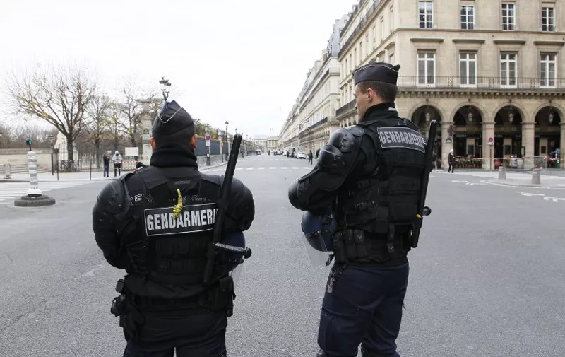 French police stand guard on November 30, 2015 on Rue de Rivoli in Paris, closed to traffic due to the COP21 Climate change conference. More than 150 world leaders are meeting under heightened security, for the 21st Session of the Conference of the Parties to the United Nations Framework Convention on Climate Change (COP21/CMP11), also known as Paris 2015 from November 30 to December 11. AFP PHOTO / MATTHIEU ALEXANDRE / AFP / MATTHIEU ALEXANDRE