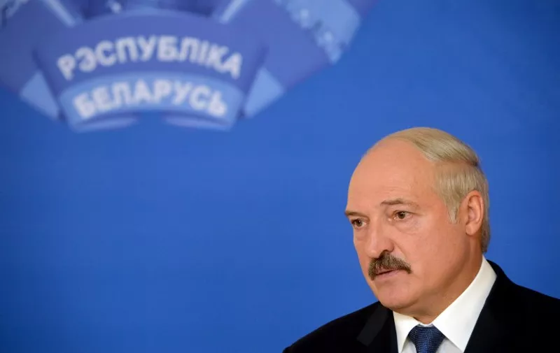 Belarus' President Alexander Lukashenko speaks with journalists during presidential elections at a polling station in Minsk on October 11, 2015. Belarussians began voting on October 11 in an election that is likely to see authoritarian President Alexander Lukashenko claim a fifth term, with the EU possibly lifting sanctions against him if the polls take place without incident. AFP PHOTO / MAXIM MALINOVSKY