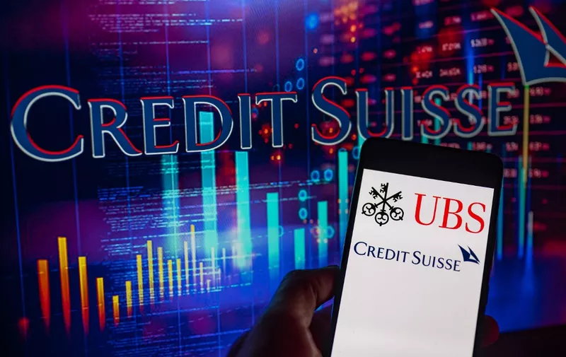Credit Suisse logo with UBS  displayed on mobile with UBS logo seen in the background. On 19 March 2023 in Brussels, Belgium.  (Photo illustration by Jonathan Raa/NurPhoto) (Photo by Jonathan Raa / NurPhoto / NurPhoto via AFP)