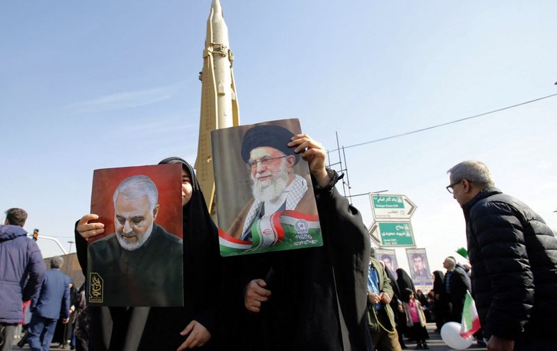 Women raise portraits of Iran's Supreme Leader Ayatollah Ali Khamenei (R) and slain top Iranian commander Qasem Soleimani in front of a Sejil surface-to-surface missile, as people gather to mark the 45th anniversary of the Islamic revolution in Tehran on February 11, 2024. Iran marked 45 years since the Islamic revolution with a ceremony on February 11, in which the country's president condemned arch foe Israel and demanded it be expelled from the United Nations. (Photo by AFP)