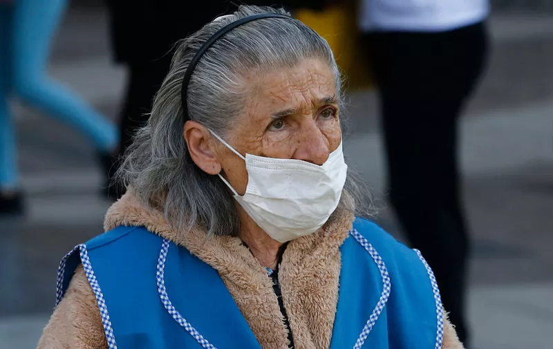 SANTIAGO, CHILE - MARCH 24: An elderly woman wears a face mask during the Covid-19 pandemic on March 24, 2020 in Santiago, Chile. The "state of catastrophe" declared by president Sebastian Piñera gives the government extraordinary powers to restrict freedom of movement and assure food supply and basic services for 90 days to confront the spread of COVID-19.  (Photo by Marcelo Hernandez/Getty Images)