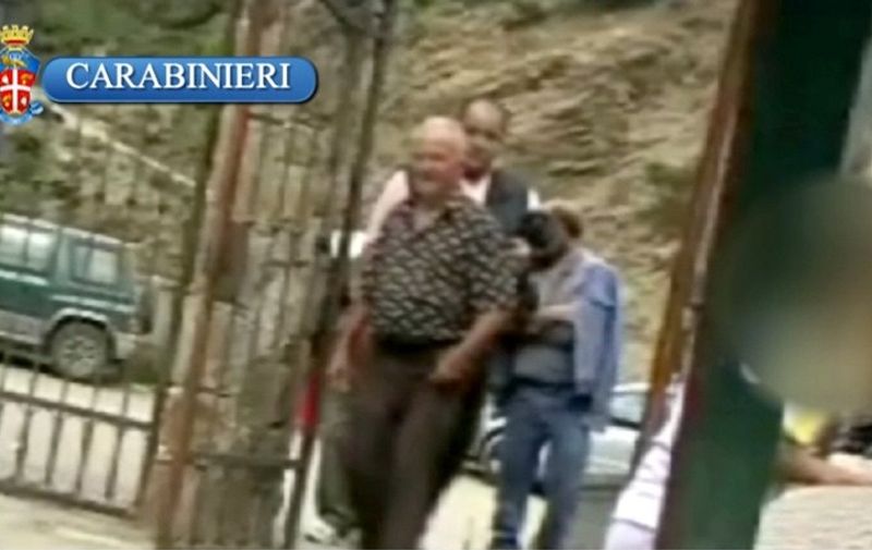 A grab from a video released on July 14, 2010 by Italian Carabinieri shows 'Ndrangheta mafia boss Domenico Oppedisano (C) and other unknow people meeting arriving at the Polsi sanctuary in Calabria, southern Italy. Italian police dealt a major blow to the country's most powerful mafia clan, arresting on July 13 the top boss of the 'Ndrangheta syndicate, Oppedisano, and more than 300 other suspected members. In recent decades, the 'Ndrangheta has become the largest and most feared of Italy's four large organized crime syndicates, which include Sicily's Cosa Nostra, the Camorra in the area of Naples and the smaller Sacra Corona Unita in the southeastern region of Puglia.   AFP PHOTO / HO /Italian Carabinieri / AFP PHOTO / Italian Carabinieri / ITALIAN CARABINIERI