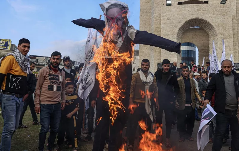 Palestinian protesters set on fire posters depicting Israeli far-right Minister of National Security Itamar Ben-Gvir, during a rally in Rafah in the southern Gaza Strip, on  January 4, 2023. (Photo by SAID KHATIB / AFP)