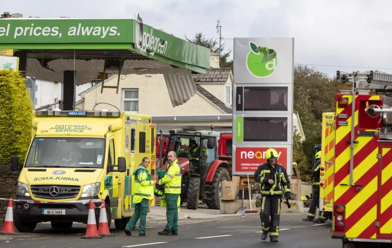 Emergency services attend the scene following an explosion in Creeslough, in the north west of Ireland on October 8, 2022. - At least nine people have been killed in an explosion at a petrol station in County Donegal in Ireland's northwest, police said on Saturday. (Photo by Paul Faith / AFP)
