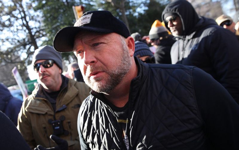 (FILES) In this file photo taken on January 19, 2020 Radio show host Alex Jones joins thousands of gun rights advocates attending a rally organized by The Virginia Citizens Defense League on Capitol Square near the state capitol building in Richmond, Virginia. - A Texas judge on August 4, 2022 denied a request for a mistrial by Alex Jones after his lawyers mistakenly turned over the far-right conspiracy theorist's cellphone records to the opposing attorneys. (Photo by WIN MCNAMEE / GETTY IMAGES NORTH AMERICA / AFP)