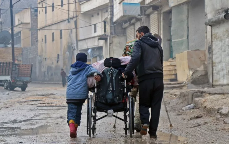 Syrian civilians leave towards safer rebel-held areas in Aleppo, on December 13, 2016, during an operation by Syrian government forces to retake the embattled city.
UN chief Ban Ki-moon expressed alarm over reports of atrocities against civilians Monday, as the battle for Aleppo entered its final phase with Syrian government forces on the verge of retaking rebel-held areas of the city.

 / AFP PHOTO / STRINGER