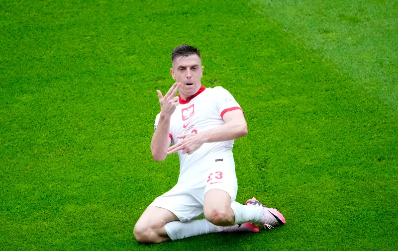 Poland's Krzysztof Piatek celebrates after scoring his side's first goal during a Group D match between Poland and Austria at the Euro 2024 soccer tournament in Berlin, Germany, Friday, June 21, 2024. (AP Photo/Petr Josek)