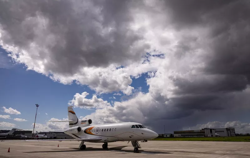 This photograph taken on April 12, 2023 shows a Dassault Falcon 900 airplane parked on the tarmac of Le Bourget Airport in Le Bourget, Northern Paris. (Photo by Thomas SAMSON / AFP)