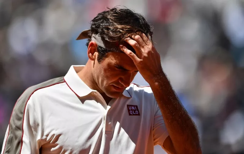 (FILES) This file photo taken on June 07, 2019 shows Switzerland's Roger Federer during his men's singles semi-final match of The Roland Garros 2019 French Open tennis tournament in Paris. - Men's Grand Slam singles record-holder Roger Federer said on June 10, 2020 he would be sidelined until 2021 after undergoing keyhole surgery on his right knee. (Photo by Martin BUREAU / AFP)