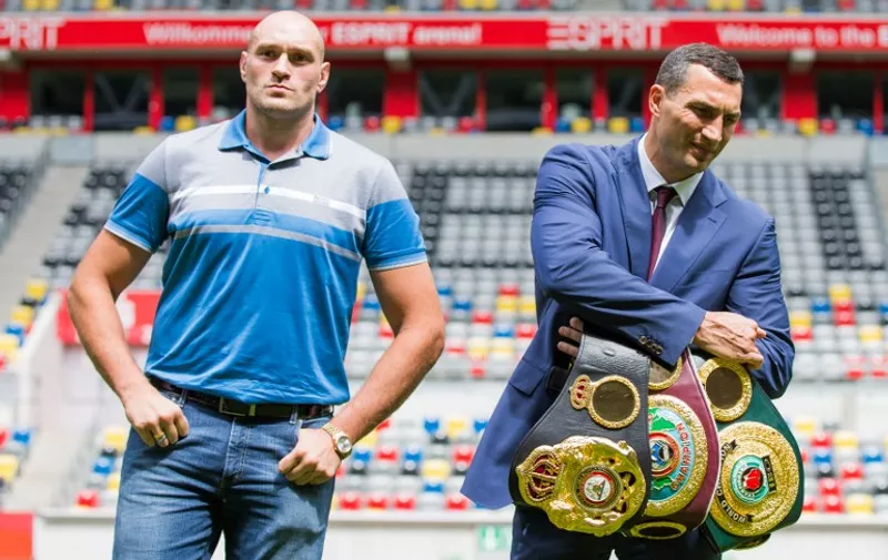 Ukrainian box champion Wladimir Klitschko (R) and his challenger, Tyson Fury of Britain, pose on the sidelines of a press conference at the Espri Arena stadium in Duesseldorf, western Germany, on July 21, 2015. Klitschko is to defend his WBA, IBF and WBO heavyweight world titles against Tyson Fury of Britain on July 24, 2015.    AFP PHOTO / DPA / ROLF VENNENBERND   +++   GERMANY OUT