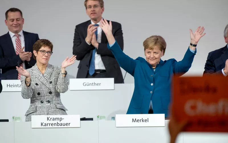 HAMBURG, GERMANY - DECEMBER 07: German Chancellor and leader of the German Christian Democrats (CDU) Angela Merkel (R) and Annegret Kramp-Karrenbauer (L) react after Merkels last speech as CDU leader at the federal executive board meeting on December 7, 2018 in Hamburg, Germany. German Chancellor and leader of the German Christian Democrats (CDU) Angela Merkel will step down as leader of the party following an 18-year reign. CDU delegates will elect today a successor from a choice of three candidates: Annegret Kramp-Karrenbauer, whom Merkel favors, Friedrich Merz and Jens Spahn. (Photo by Thomas Lohnes/Getty Images)