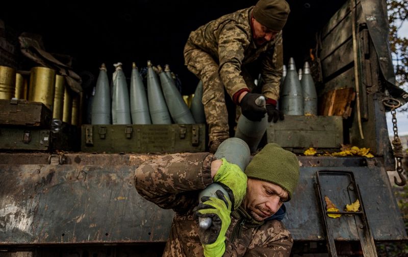 Ukrainian artillerymen unload shells from a military truck at a position on the front line near the town of Bakhmut, in eastern Ukraine's Donetsk region, on October 31, 2022, amid Russian invasion of Ukraine. (Photo by Dimitar DILKOFF / AFP)