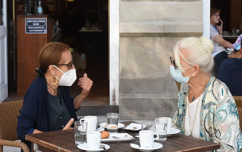 Women wearing face masks as a preventive measure talk at Moderno coffeehouse.
There are new 44 cases of coronavirus in Pontevedra's province. Spanish Galicia region has confirmed that the new cases have increased by 670 and 27 people with COVID-19 are hospitalised.
Coronavirus Situation in Pontevedra, Spain - 10 Aug 2020,Image: 551469716, License: Rights-managed, Restrictions: , Model Release: no
