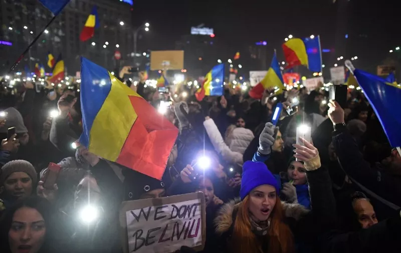 Protesters turn on the lights of their mobile phones as they protest in front of the government headquarters against the government's contentious corruption decree in Bucharest, Romania on February 5, 2017.
The placard reads: "WE DON'T BE-LIVIU (Dragnea)".
Romania's government formally repealed contentious corruption legislation that has sparked the biggest protests since the fall of dictator Nicolae Ceausescu in 1989, ministerial sources said. The emergency decree, announced on Tuesday (January 31, 2017), would have decriminalised certain corruption offences, raising concerns in Romania and outside that the government was easing up on fighting graft. Centre-right President Klaus Iohannis, elected in 2014 on an anti-graft platform, previously had called the decree "scandalous" and moved to invoke the constitutional court. / AFP PHOTO / Daniel MIHAILESCU