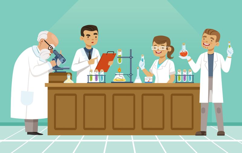 Professional chemists in their laboratory makes different experiments on the table. Male and female medical workers. Chemistry science education in laboratory, research and experiment