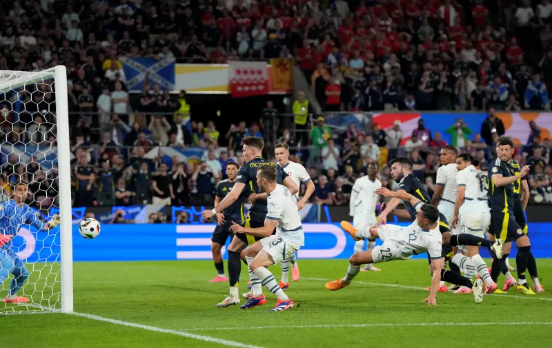 Scotland's Grant Hanley, center right, sees his header hit the post during the Group A match between Scotland and Switzerland at the Euro 2024 soccer tournament in Cologne, Germany, Wednesday, June 19, 2024. (AP Photo/Martin Meissner)
