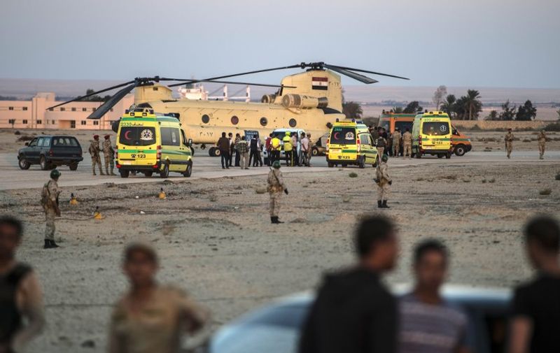Egyptian ambulances carrying the corpses of Russian victims of a Russian passenger plane crash in the Sinai Peninsula, off load the bodies into a military aircraft at Kabret military air base by the Suez Canal on October 31, 2015. Egypt's government said 15 bodies have been recovered and transferred to a morgue so far from the site of the crash.  AFP PHOTO / KHALED DESOUKI