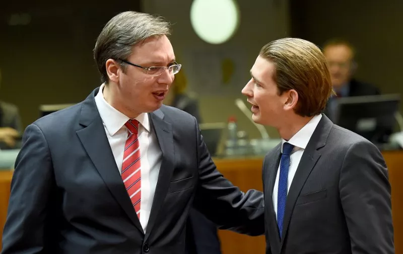 Serbia's Prime Minister Aleksandar Vucic (L) and Austria's Foreign Minister Sebastian Kurz speak to one another at an EU-Serbia association council meeting on December 14, 2015 at the European Council in Brussels. / AFP / EMMANUEL DUNAND